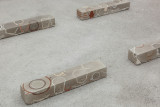 Javier Carro Temboury, <em>Café Transversal III</em>, 2024, Ceramic cups and dishes, coffee leftovers, cast in concrete then sliced; Wooden table, sliced – Thumbnail preview